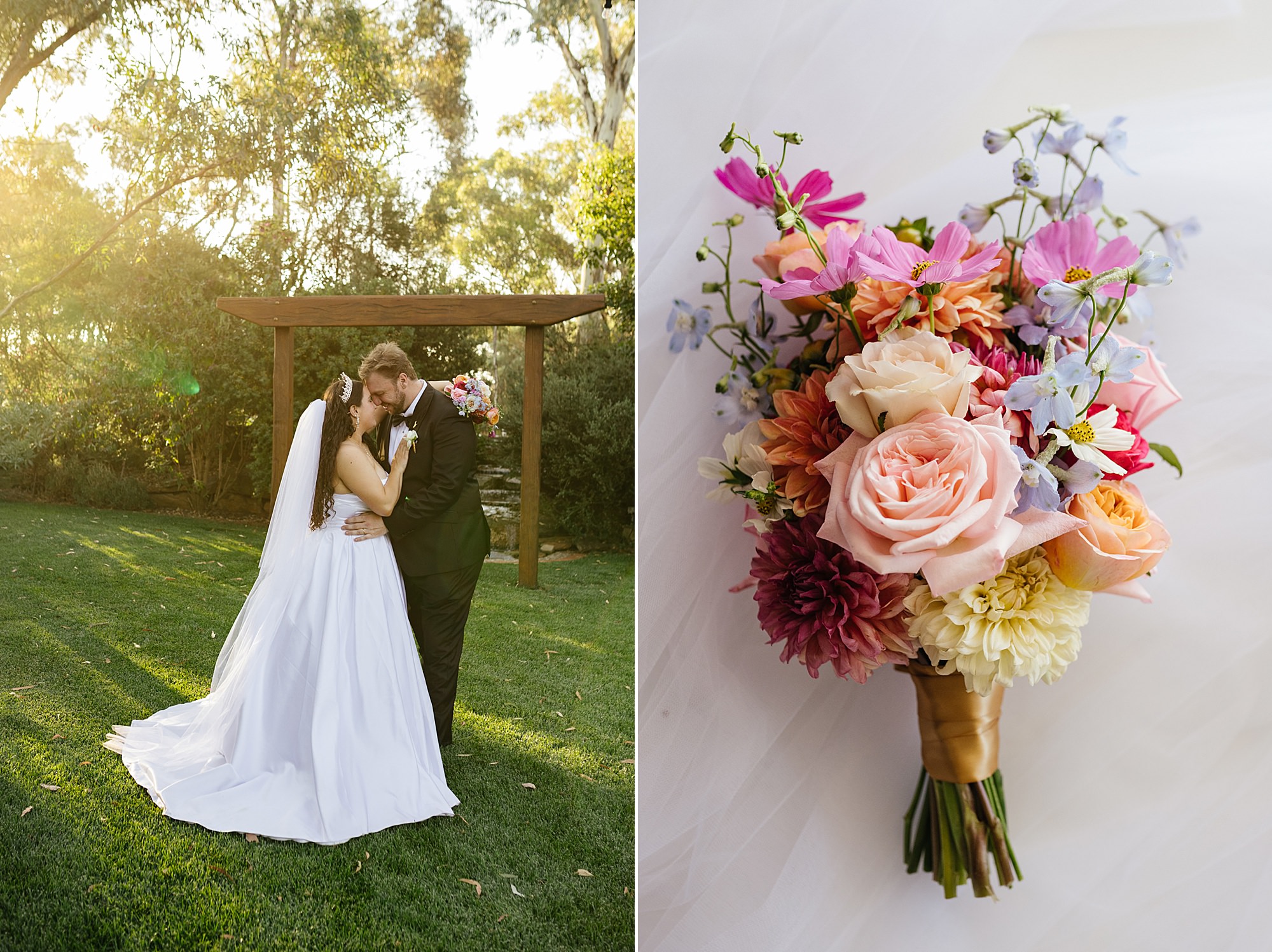 Bride and groom standing in a lush green garden at sunset with a colorful bouquet of flowers beside them