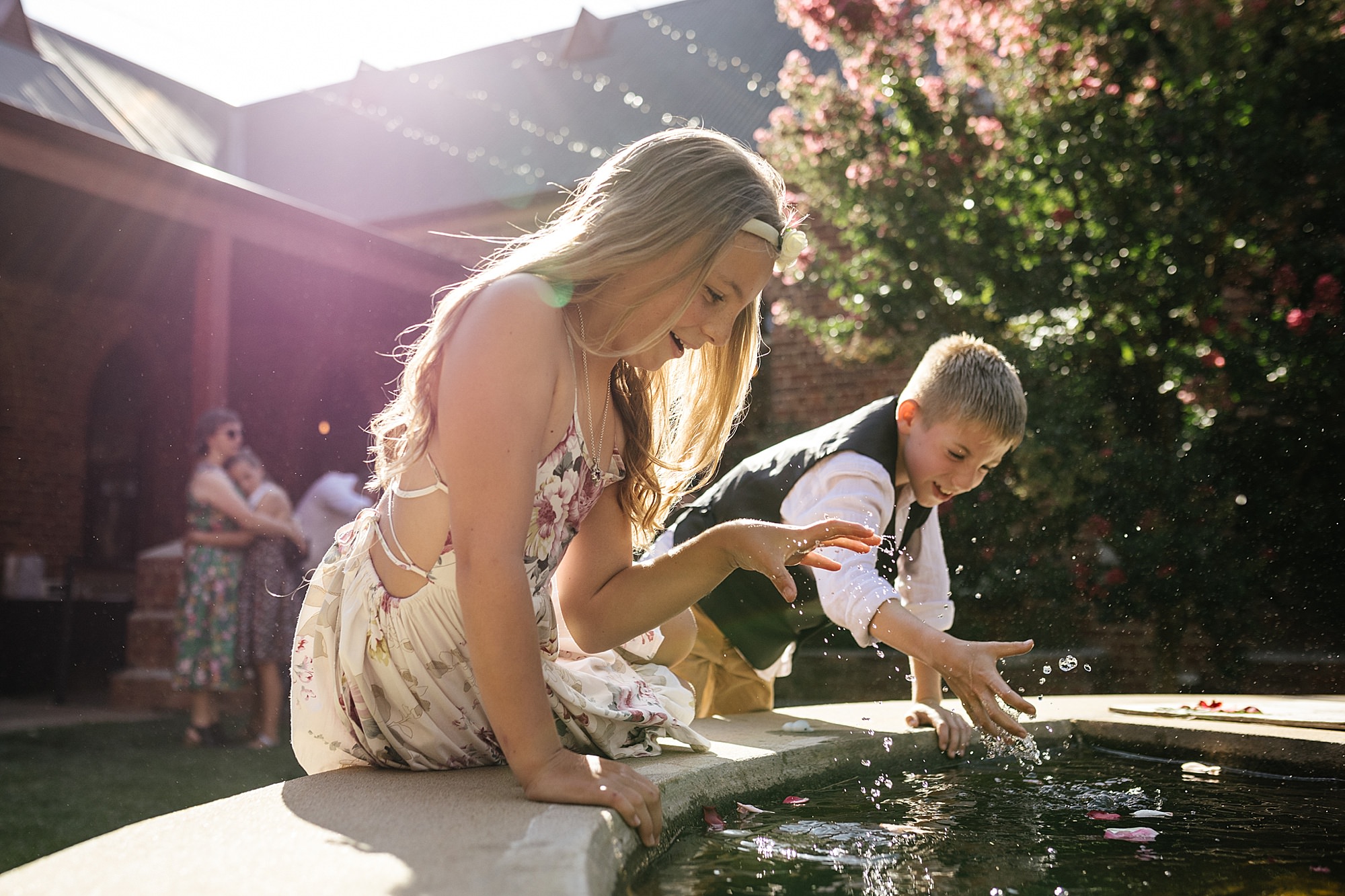 Kids joyfully playing with water in a pond. 
