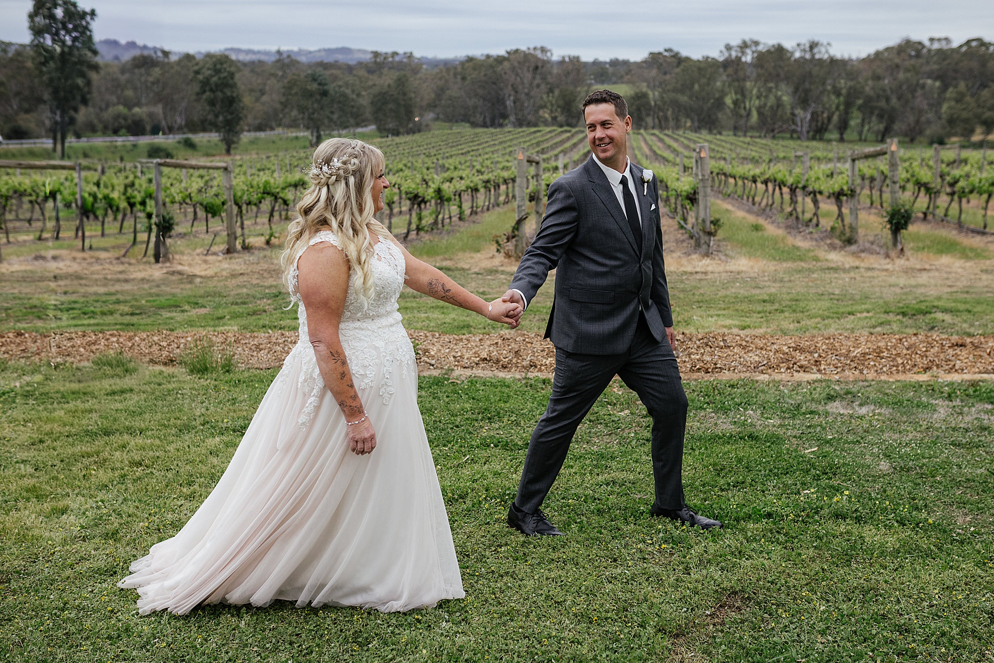 Bride & groom leading each other at St Anne's winery in Bendigo.