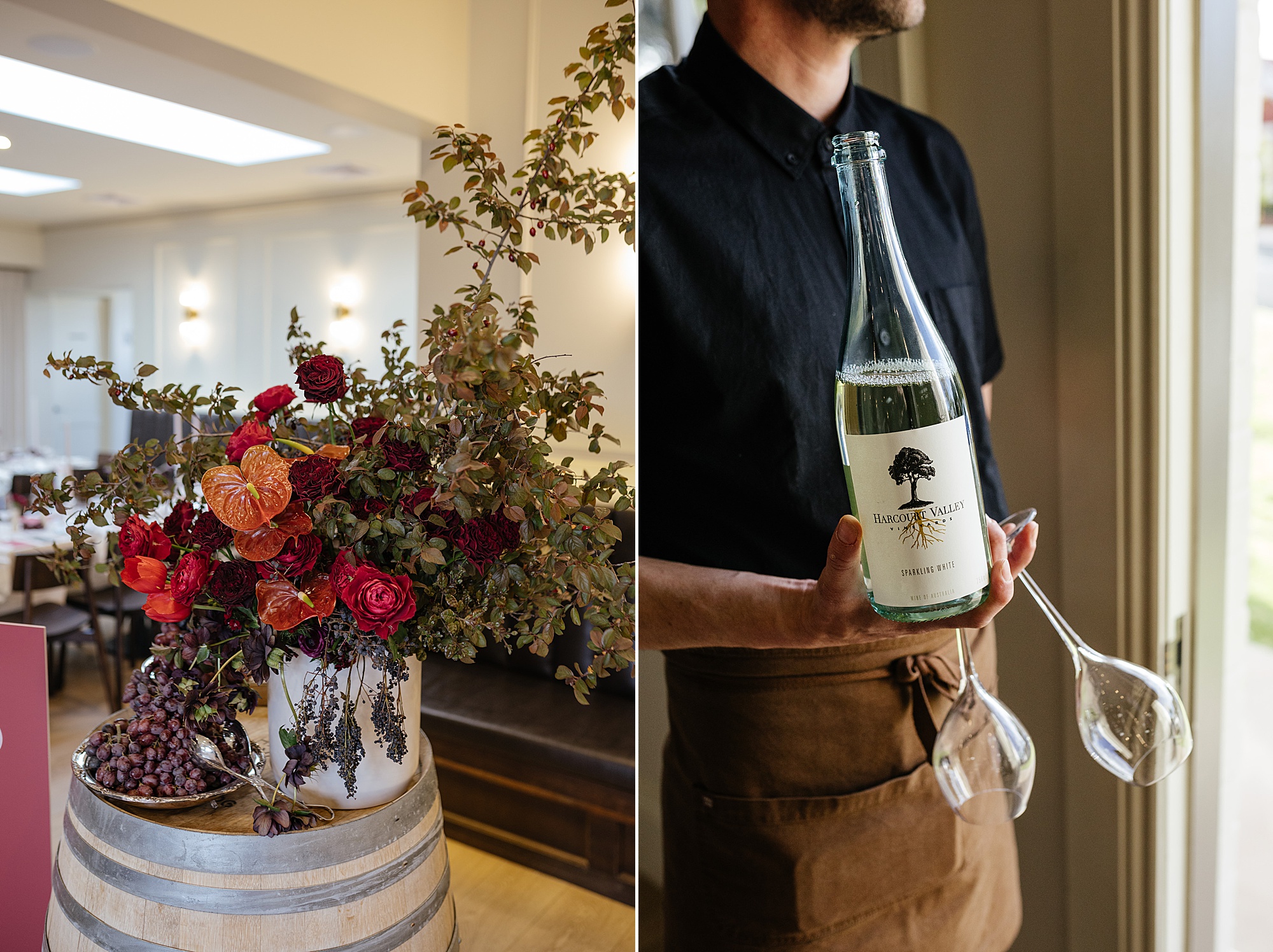 Burgundy floral arrangement with waiter holding glasses.